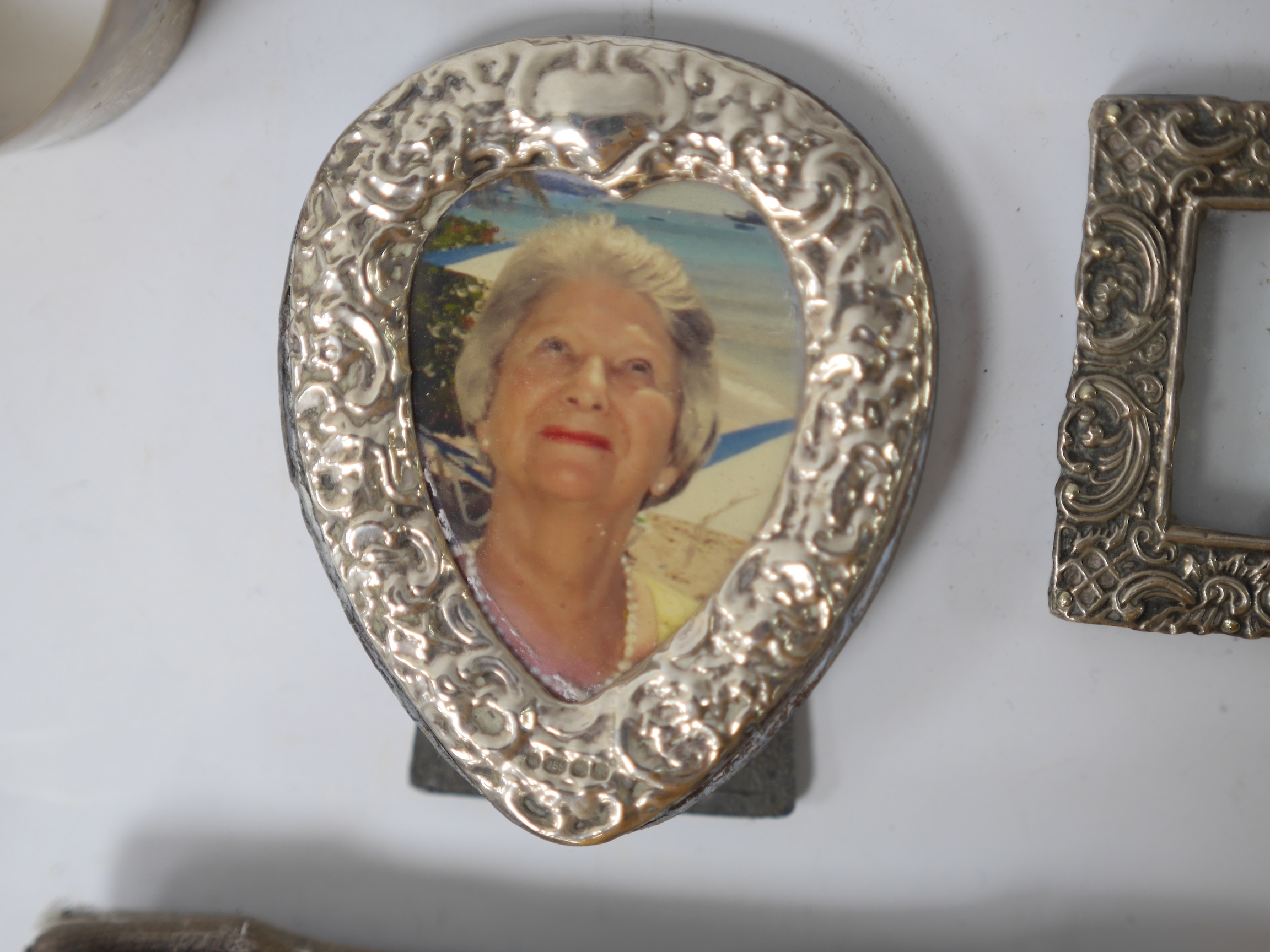 Four small mounted photograph frames, including a double by Saunders & Shepherd, Birmingham, 1905, 45mm, a silver dish, a silver napkin ring and five items of silver flatware. Condition - poor to fair